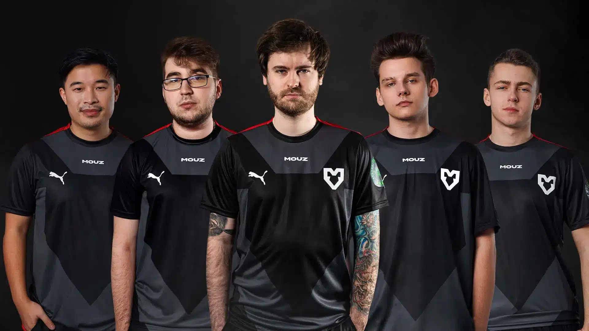 Five players from the MOUZ CS2 esports team in matching jerseys.