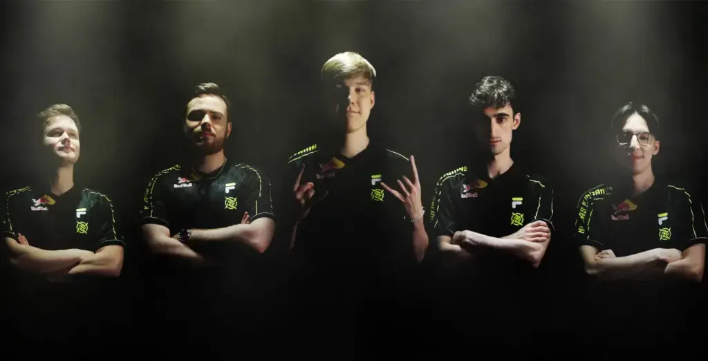 Five members of the Ninjas in Pyjamas esports team posing with arms crossed in dramatic lighting
