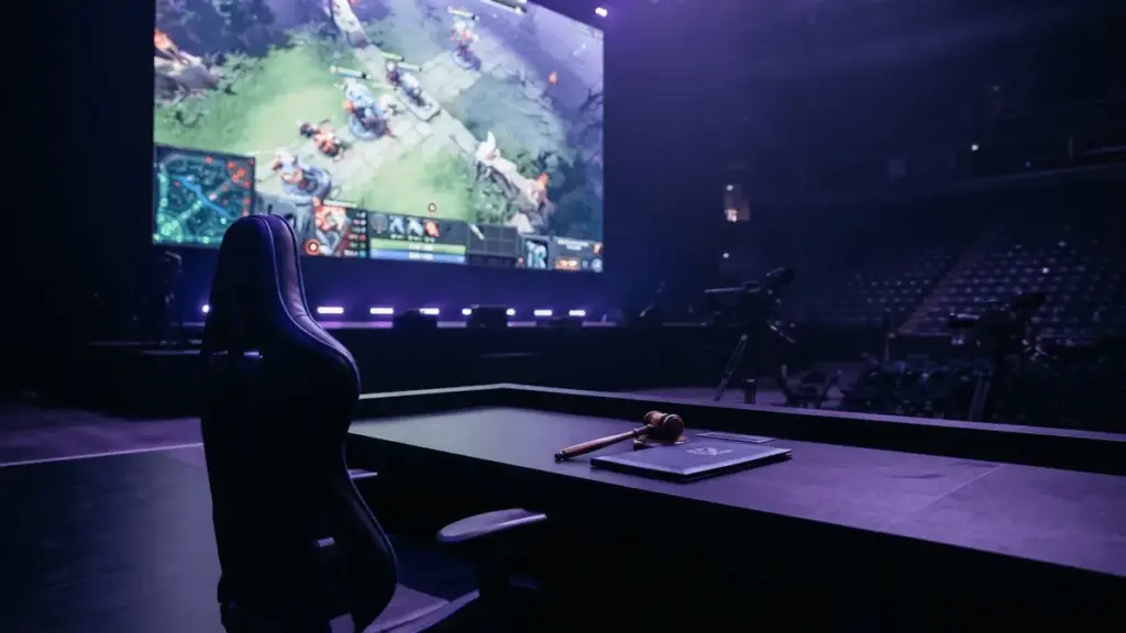Empty esports gaming chair on tournament stage with Dota 2 interface on screen representing player suspension