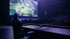 Empty esports gaming chair on tournament stage with Dota 2 interface on screen representing player suspension