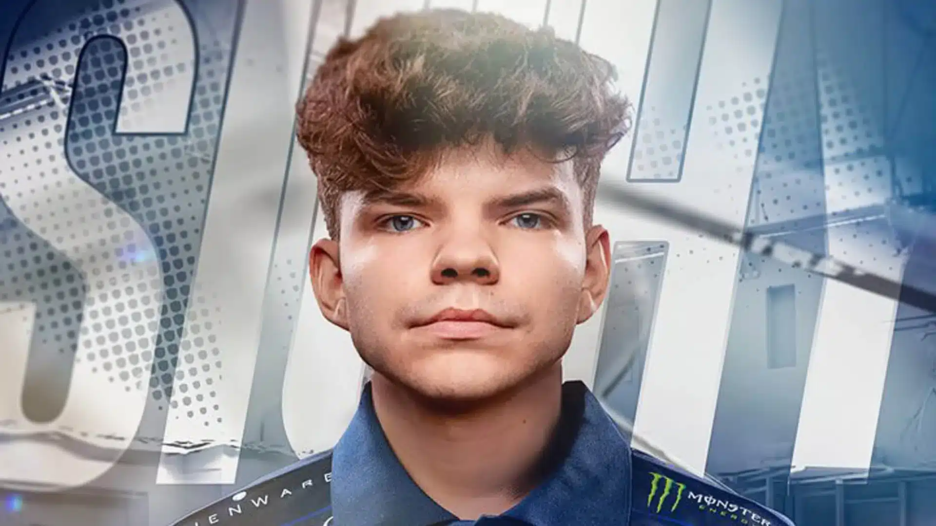 Close-up portrait of a young male gamer with curly hair, wearing a blue esports jersey.
