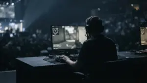 Silhouetted esports player competing at a tense Counter-Strike LAN tournament station