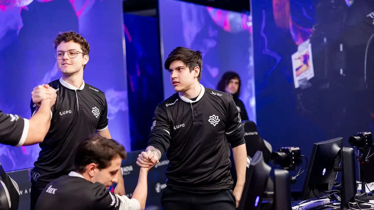 Professional esports players in black team jerseys shaking hands during a Counter-Strike tournament.