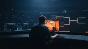 Cinematic esports LAN stage showing an orange-lit playoff path after a dominant group-stage run