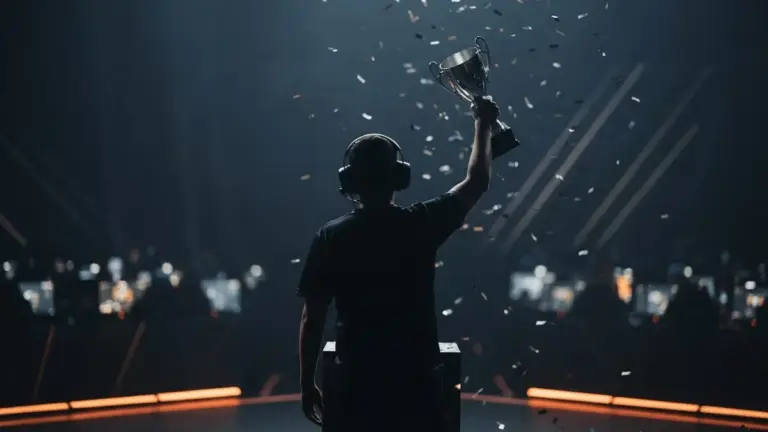 Faceless esports player raises a trophy after a Counter-Strike LAN final in a dark orange-lit arena