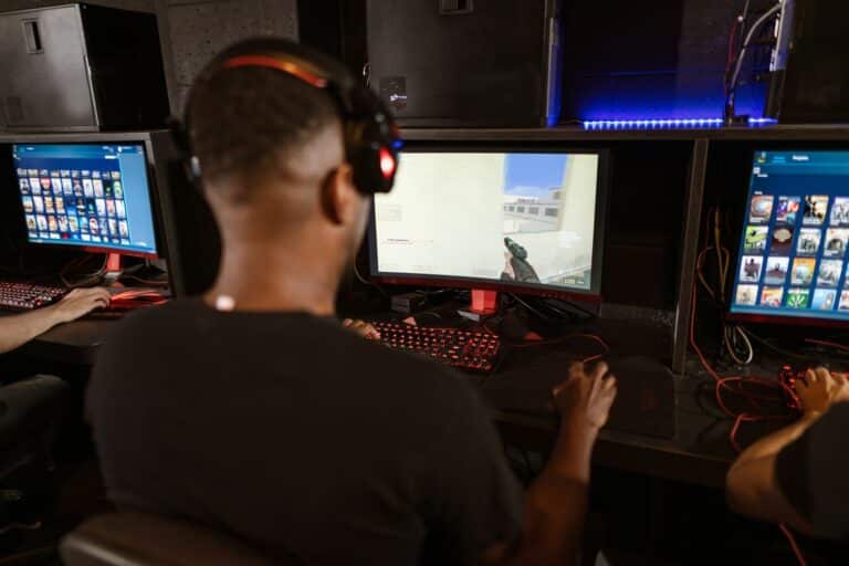 Counter-Strike player wearing a headset playing a first-person shooter on a gaming PC